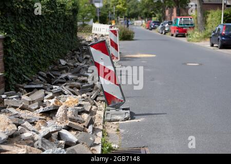 paving work to renew the walkway, destroyed old stones behind barriers Stock Photo
