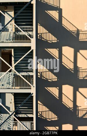 Fire escape, multiple units, apartment building, early morning light. Stock Photo