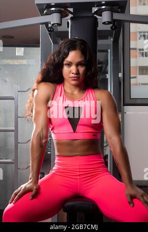 portrait of beautiful young hispanic female bodybuilder in gym Stock Photo