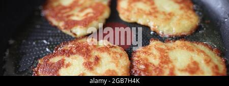 Cooking potato pancakes lie in frying pan Stock Photo