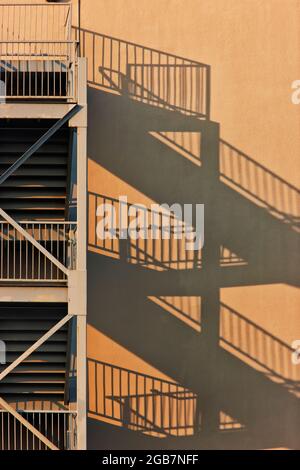Fire escape, multiple units, shadows resulting from evening light. Stock Photo