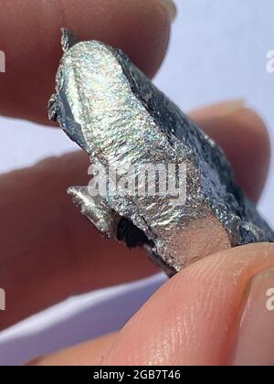raw Rhodium metal sample, rhoduim is very strong but brittle in pure form so makes it perfect for coating jewellry here is a recycled piece extracted Stock Photo