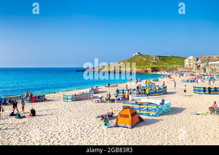 Hot summer day at Porthmeor Beach with St Nicholas Chapel and the Island in St. Ives, Cornwall, UK Stock Photo