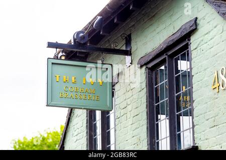 Sign On The Exterior Of The Ivy Cobham Brasserie, Cobham, Surrey, Uk 