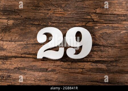 twenty nine 29 - White wooden number on rustic background Stock Photo
