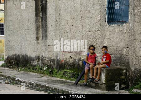 Valencia, Carabobo, Venezuela. 31st July, 2021. July 31, 2021. Two children remain seated at the door of the house in a popular area of the city of Valencia, Carabobo state. Photo: Juan Carlos Hernandez (Credit Image: © Juan Carlos Hernandez/ZUMA Press Wire) Stock Photo