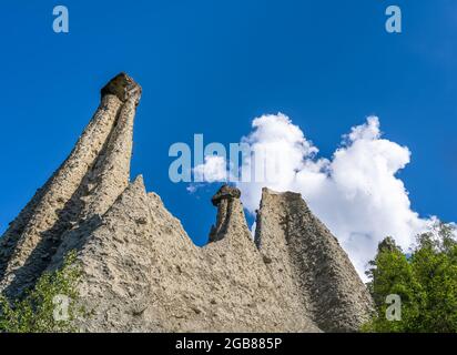 The natural earth pyramids of Euseigne in the valley of Herens are one of Switzerland's most important geological sights. Stock Photo