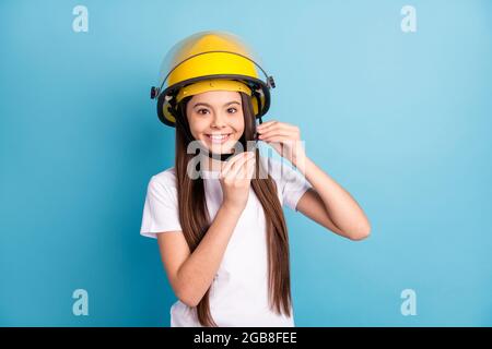 Portrait of attractive cheerful girl wearing fixing protective helmet casque isolated over vivid blue color background Stock Photo