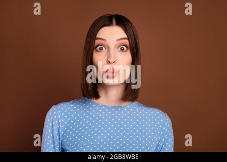 Photo of flirty brunette young lady blow kiss wear dotted shirt isolated on brown color background Stock Photo