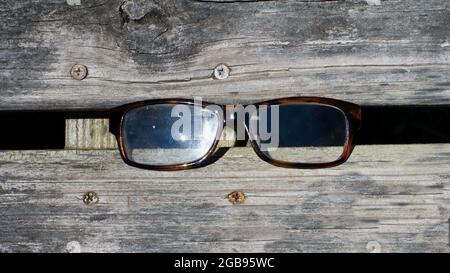 A High Angle View of a Pair of Eyeglasses on a Wooden Background Stock Photo