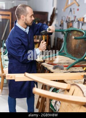 Carpenter repairing antique chair Stock Photo