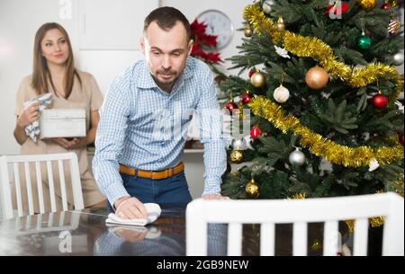 Husband wiping table Stock Photo