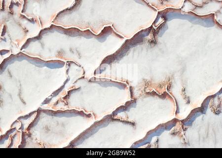 White-red texture of Pamukkale calcium travertine in Turkey, uneven pattern of big cells, close-up Stock Photo