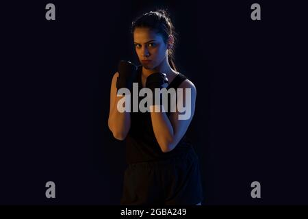 A STRONG FEMALE WRESTLER PRACTICING MOVES IN FRONT OF CAMERA Stock Photo