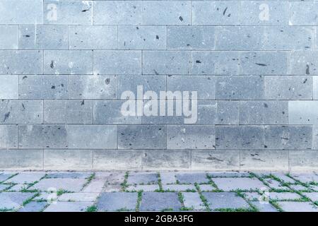 The wall with light gray, white bricks and cobblestone sidewalk decoration for background. High quality photo Stock Photo