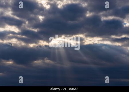 Rays of light shining throug dark clouds.Beautiful dramatic sky with sun rays.dramatic sky sun rays. Stock Photo