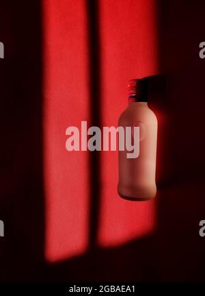 A glass bottle with merging colors. Stock Photo