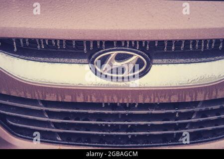 Hood of a yellow Kia Rio taxi car frozen after the first autumn frost - Moscow, Russia, November 19, 2020 Stock Photo