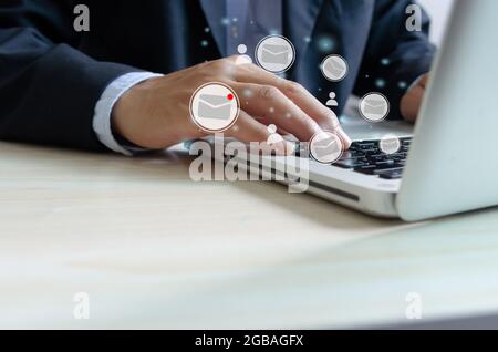 businessman hand typing on laptop keyboard checking email online. business technology on a virtual interface Stock Photo