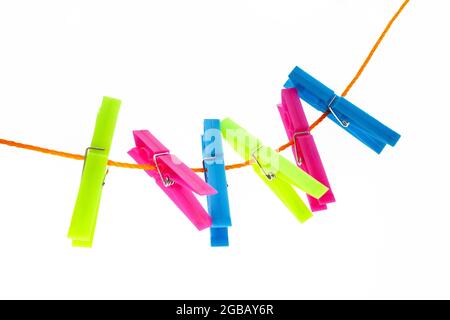 colorful clothespins on a rope on an isolated white background Stock Photo