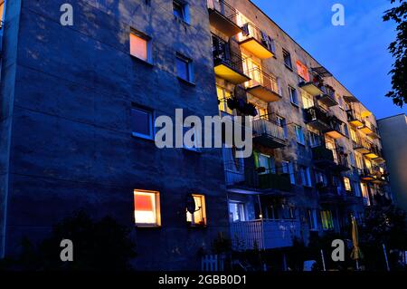 House at night among trees lit by street lamps. City, Stock Photo