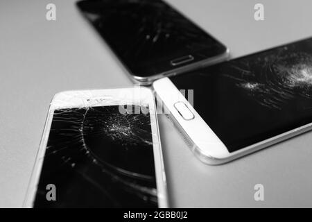 broken mobile phone display on a white background Stock Photo