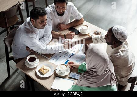 Two confident businessmen handshaking after making business deal at meeting Stock Photo