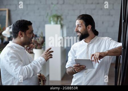 Two confident businessmen discussing points of presentation or new project Stock Photo