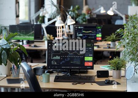 Workplace of office manager or analyst with computer monitor on the center of desk Stock Photo