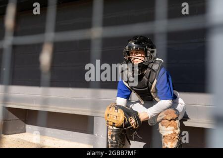 Muffin the Dog in Vintage Shoulder Pads, sitting on Locker Room Bench Next  to Football Helmet Stock Photo - Alamy