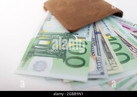 wallet with euro and dollars sticking out of it, isolated Stock Photo