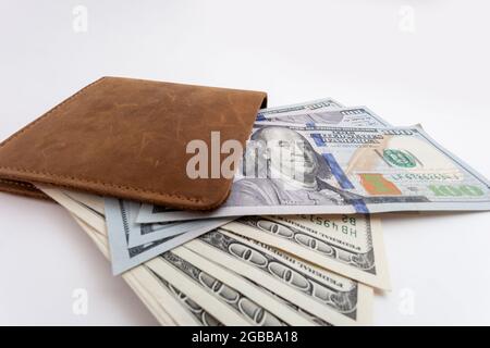 wallet with dollars sticking out of it Stock Photo