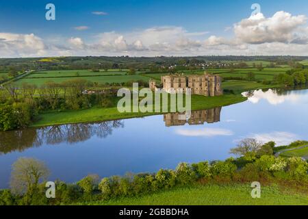 Aerial view of Carew Castle reflected in the mill pond on a still spring morning, Pembrokeshire Coast National Park, Wales, United Kingdom, Europe Stock Photo