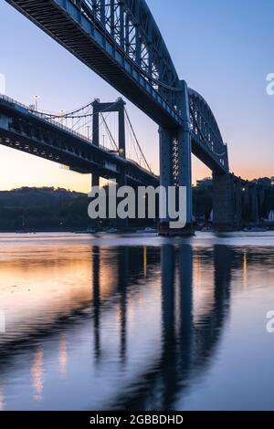 Dawn sky behind Brunel's Royal Albert Bridge and the Tamar Bridge in spring, Saltash, Cornwall, England, United Kingdom, Europe Stock Photo