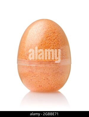 Front view of transparent egg container full of orange modelling foam beads isolated on white Stock Photo