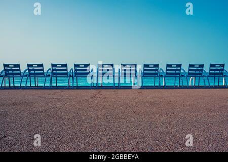 Famous blue chairs on beach of Nice, France Stock Photo