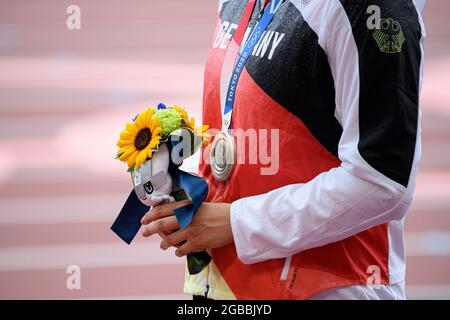 Award ceremony, victory ceremony, Kristin PUDENZ (GER), 2nd place, silver medal, silver medal, silver medalist, silver medalist, detail, medal, hands with flower arrangement, athletics, women's discus throwing, women's discus throw final, on August 2nd, 2021 Summer Olympics 2020, from 23.07. - 08.08.2021 in Tokyo/Japan. Stock Photo