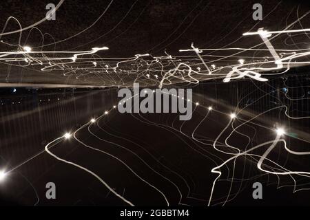 Blurred abstract light trails on a street at night. Stock Photo