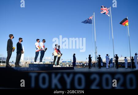Kanagawa, Japan. 3rd Aug, 2021. Gold medalists Dylan Fletcher/Stuart Bithell of Great Britain, silver medalists Peter Burling/Blair Tuke of New Zealand and Erik Heil/Thomas Ploessel of Germany attend the awarding ceremony for the sailing men's skiff 49er event at the Tokyo 2020 Olympic Games in Kanagawa, Japan, Aug. 3, 2021. Credit: Huang Zongzhi/Xinhua/Alamy Live News Stock Photo