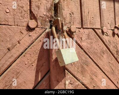 Old closed lock on a wooden door. High quality photo Stock Photo