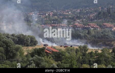 A large fire is burning from burning stubble in Sofia, Bulgaria on August, 3, 2021. The fire is burning the forest, field, houses above living areas M Stock Photo