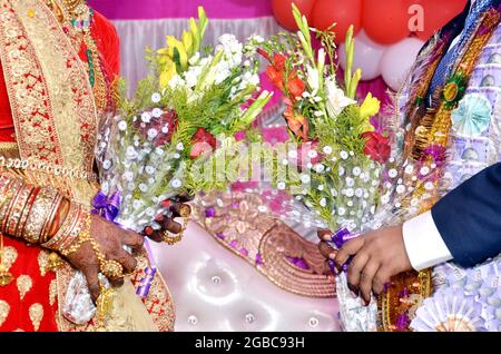 Indian Wedding Couple Holding Bouquet In Hand Stock Photo