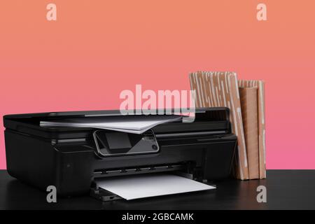 Compact home laser printer against orange background Stock Photo