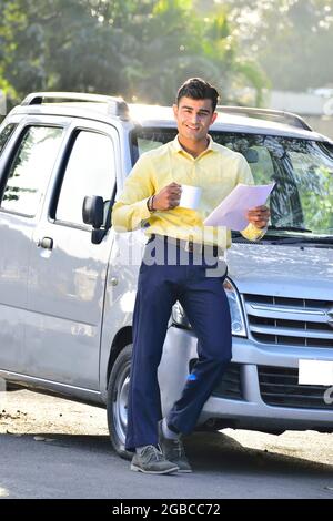 Indian Businessman Working Outdoor and Drinking Coffee Stock Photo