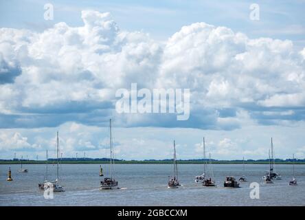 03 August 2021, Schleswig-Holstein, Brunsbüttel: Numerous ships sail out of the locks of the Kiel Canal onto the Elbe. Photo: Daniel Bockwoldt/dpa Stock Photo