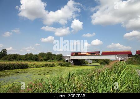 DB Cargo Class 66 loco 66039 hauling the 1055 Immingham to Scunthorpe Steelworks coal service over the River Ancholme north of Brigg on 3/7/21. Stock Photo