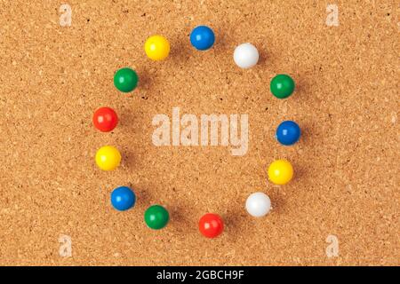 Group of thumbtacks pinned on corkboard Stock Photo