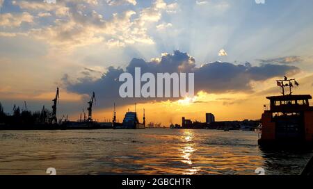 Evening sunset at the Hamburg harbour on the river Elbe. Stock Photo