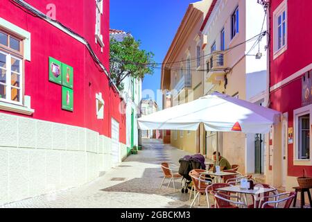 Street pavement restaurant cafe along traditional calcada cobbled street road Silves Algarve Portugal Stock Photo