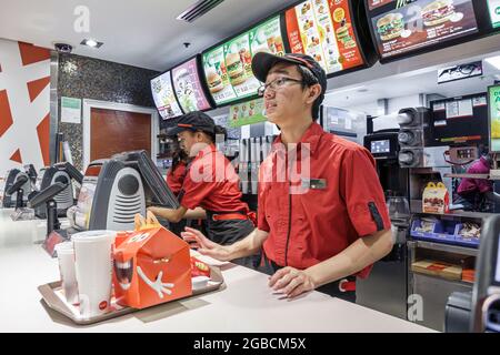 Sydney Australia,CBD Circular Quay,McDonald's restaurant fast food counter serving order tray,Asian man employee worker working, Stock Photo